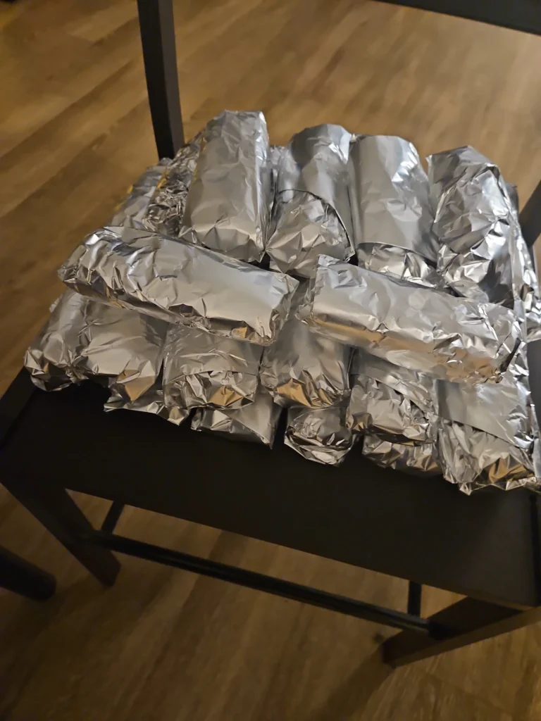Tinfoil-wrapped sausage egg and cheese wraps.