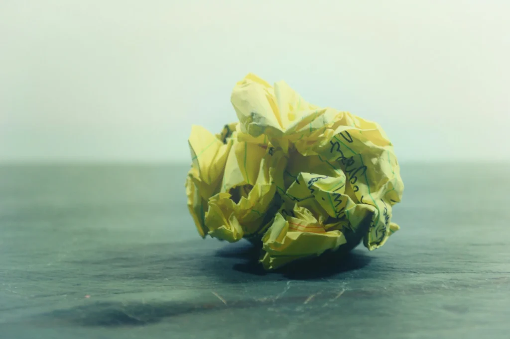 Stock image of crumpled up paper with indistinguishable writing on it.